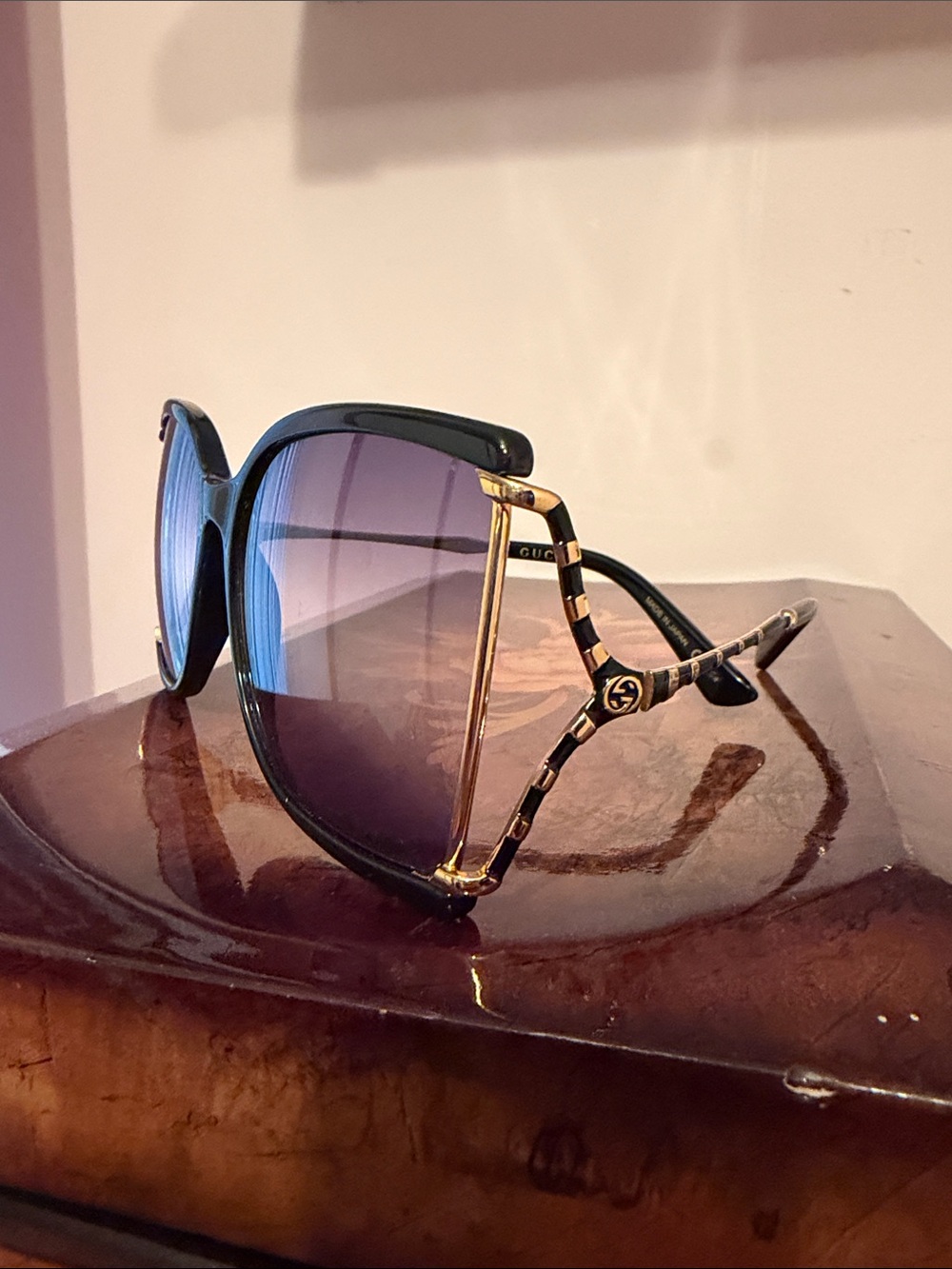 Gucci Black Frame Sunglasses with Gold Accents and Purple Gradient Lenses